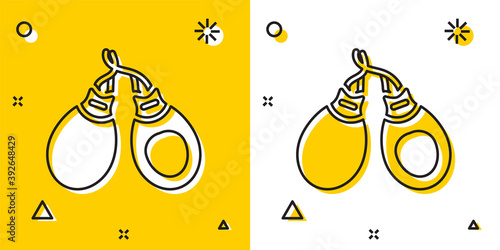 Black Musical instrument castanets icon isolated on yellow and white background. Random dynamic shapes. Vector.