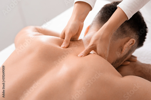 Closeup of man getting acupressure massage at spa salon