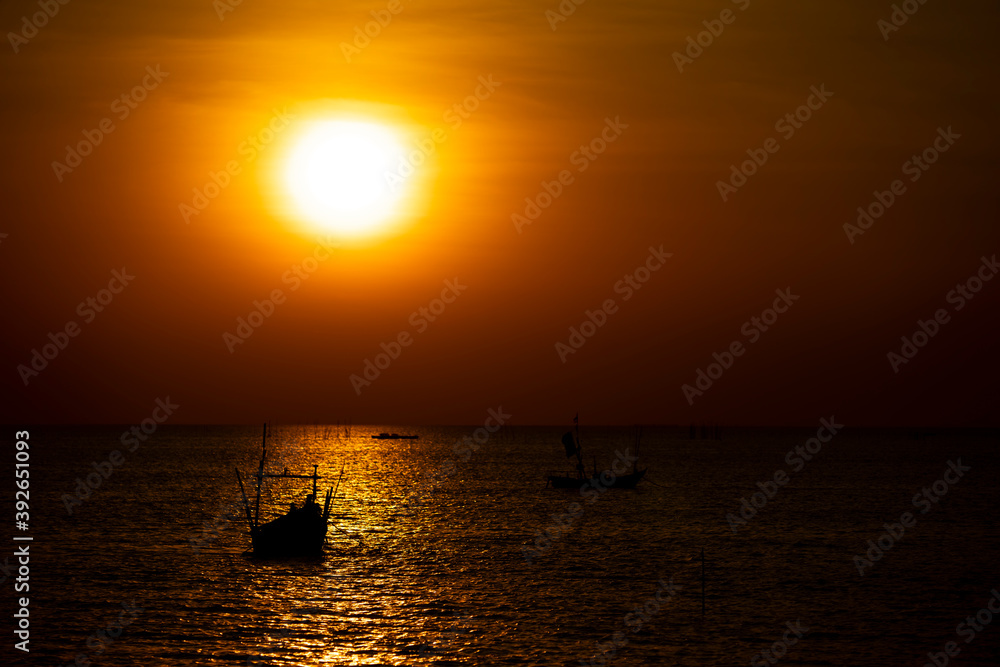 silhouette of Fishing boat At sunset On the coast of Thailand