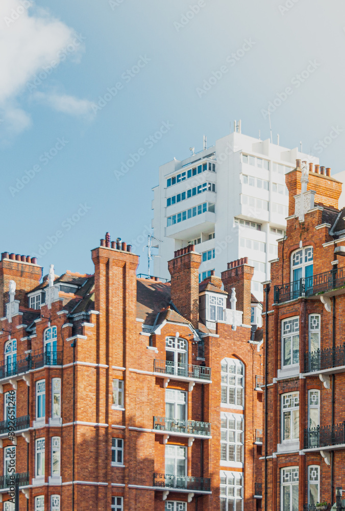 Paisaje urbano con vistas a un conjunto de edificios y un rascacielos blanco de fondo durante un día soleado en Londres