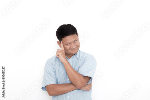 A young Asian man thinking with a confused expression