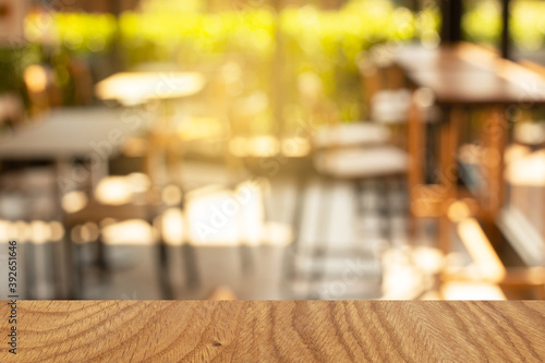 top of wood table with blur morning light in restaurant background