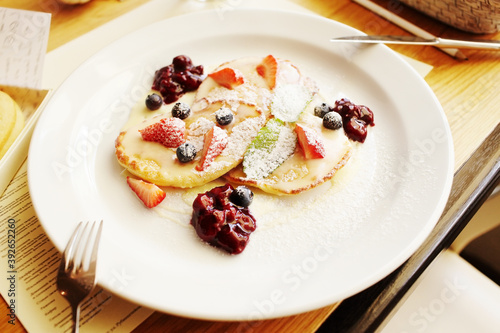 Belgian waffles with fresh fruits on the white plate