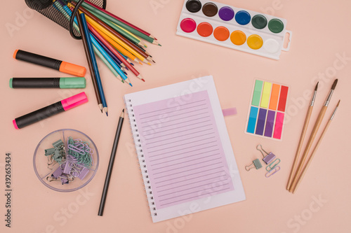 School and office supplies. background with colorful school items and stationery collection on pink background. Back to school concept