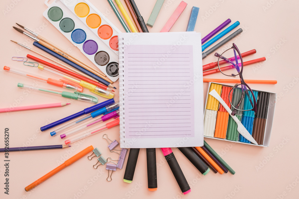 Fototapeta premium School and office supplies. background with colorful school items and stationery collection on pink background. Back to school concept