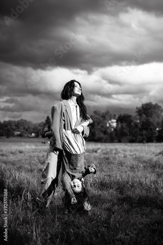 Wallpaper Mural Mom and daughter have fun together. Weekend in nature near the forest in the grass Torontodigital.ca
