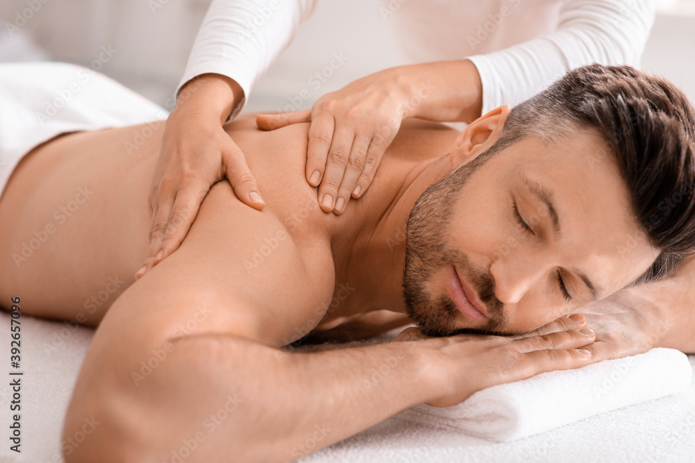 Closeup of handsome man having full body massage at spa Closeup of handsome man having full body massage at spa
