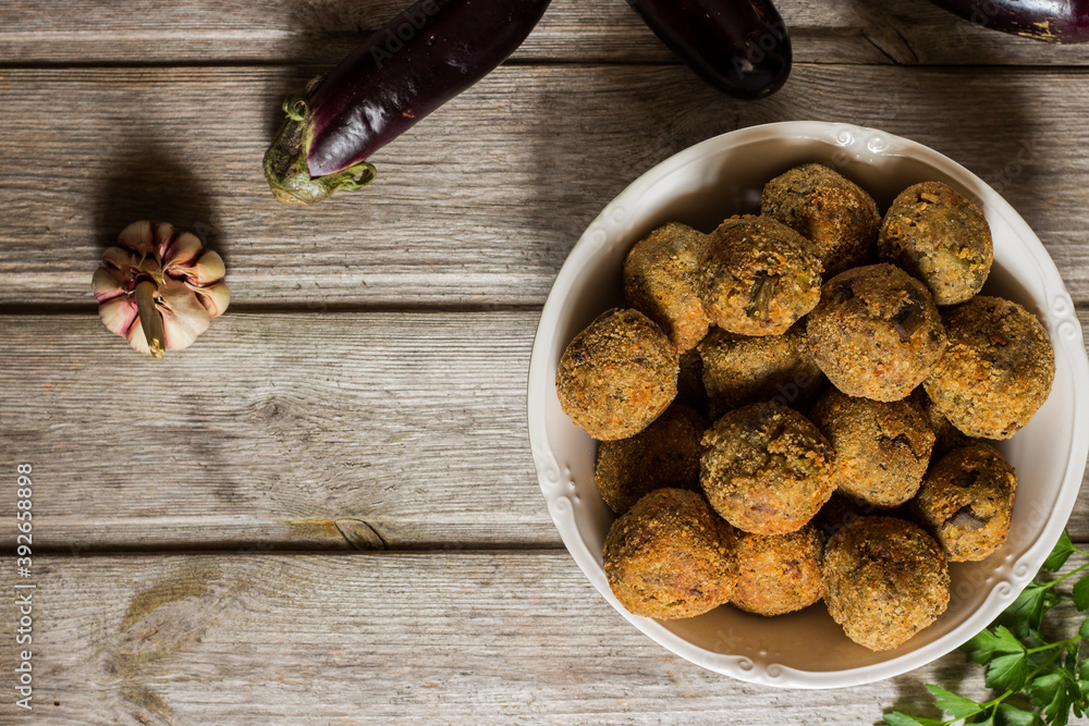 Meatless eggplant meatballs on wooden background. Meatless eggplant meatballs on wooden background.