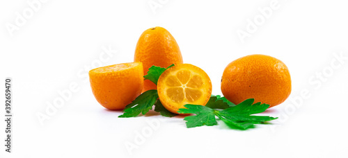 Cumquat small citrus winter fruit composition in a cut, illustrative photo on white isolated background banner
