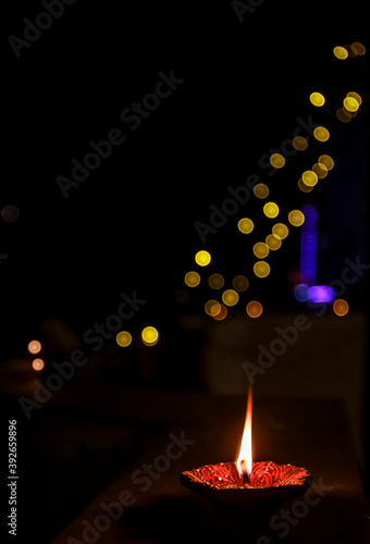 Colorful and sparkling clay diya lamps ready for decorating or illuminating house on diwali, a festival of light. Lighting bokeh. photo