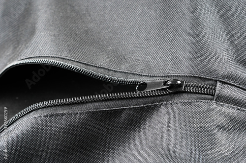 closeup shot of a black zipper  on a black leather jacket.