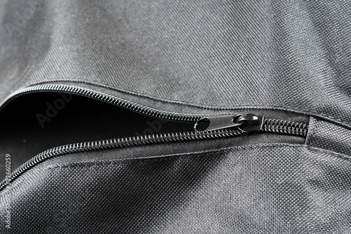 closeup shot of a black zipper  on a black leather jacket. photo