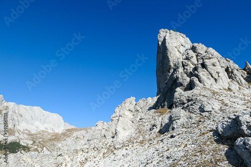 A view on a massive mountain wall in Alps in Hochschwab region, Austria. The slopes are really steep and dangerous to climb. Rocky landscape. Remote place, with no people. Freedom and wilderness photo