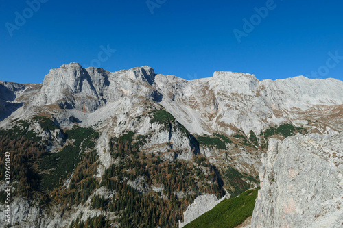 A view on a massive mountain wall in Alps in Hochschwab region, Austria. The slopes are really steep and dangerous to climb. Rocky landscape. Remote place, with no people. Freedom and wilderness