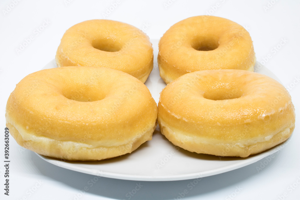 Homemade traditional glazed donut donut plate and white background
Homemade traditional glazed donut donut plate and white background