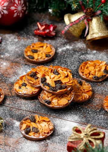 Fototapeta Christmas Chocolate Florentines cookies with almond and raisins with decoration,