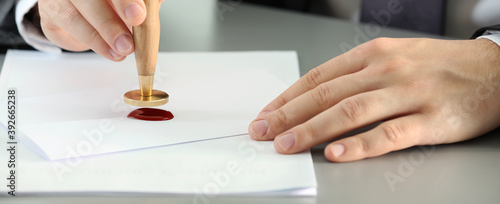 Fotografi Notary stamping document at table, closeup. Banner design