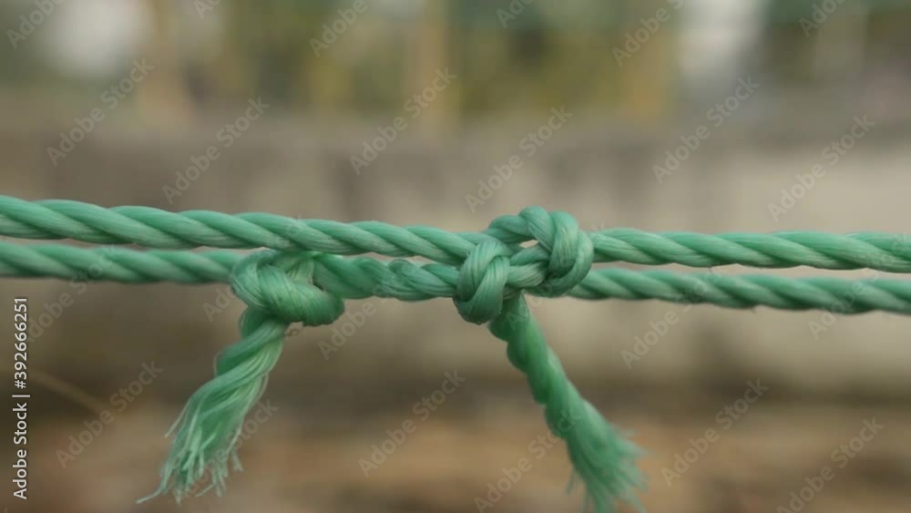 Rope tie knot Closeup. Rope with a two tied knot in the middle isolated from background. A symbol of trust, strength, safety support faith and togetherness concept. Illustrative conceptual Footage. Rope tie knot Closeup. Rope with a two tied knot in the middle isolated from background. A symbol of trust, strength, safety support faith and togetherness concept. Illustrative conceptual Footage.