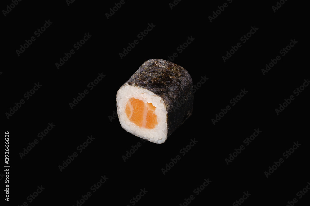 hosomaki roll with salmon isolated on black hosomaki roll with salmon isolated on black