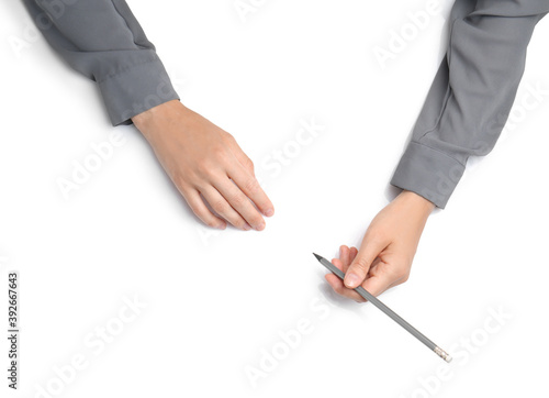 Woman with pencil on white background, top view. Closeup of hands