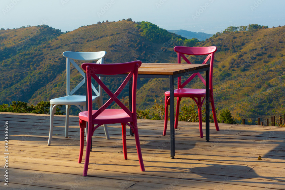 Chairs and empty table with mountains background Chairs and empty table with mountains background