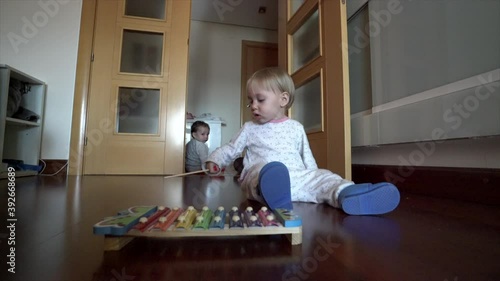 little girl playing with xylophone