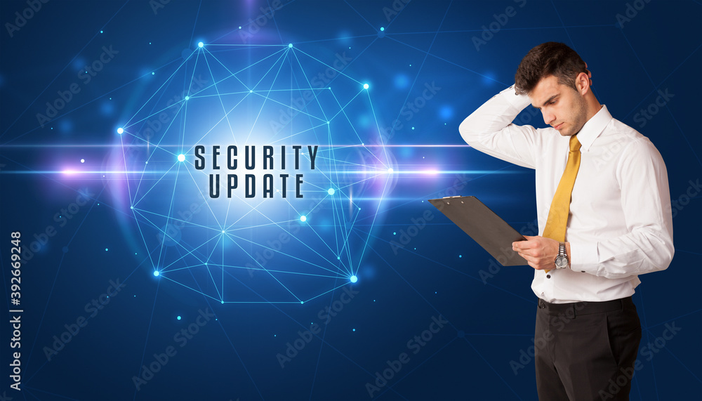 Businessman thinking about security solutions with SECURITY UPDATE inscription Businessman thinking about security solutions with SECURITY UPDATE inscription
