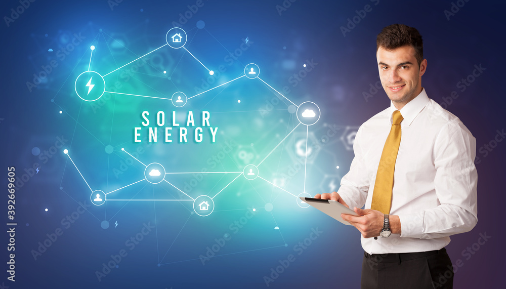 Businessman in front of cloud service icons with SOLAR ENERGY inscription, modern technology concept Businessman in front of cloud service icons with SOLAR ENERGY inscription, modern technology concept