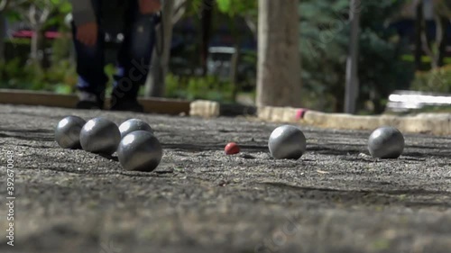 slow motion closeup of petanque balls colliding during play.