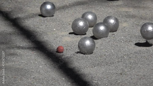 slow motion closeup of petanque balls colliding during play.