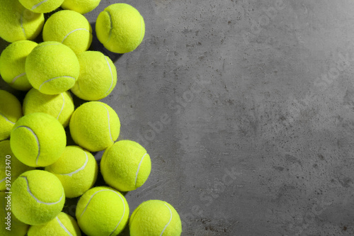 Tennis balls on grey table, flat lay. Space for text © New Africa
