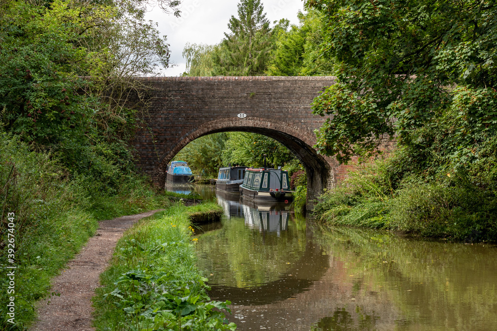Canal boats beyond a bridge