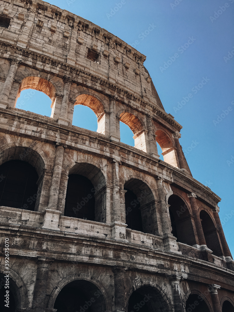 Colosseum in Rome against the blue sky. Traveling to Italy, Rome. City Landmark.