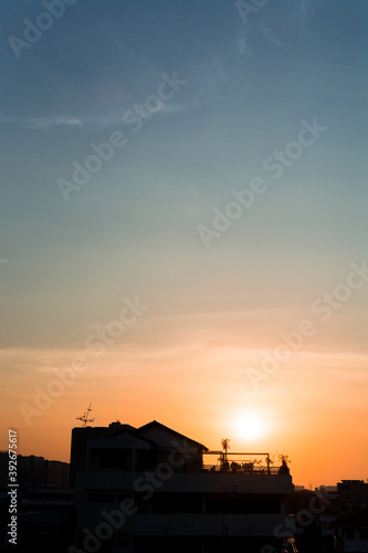 Silhouette of building during sunset. blue and orange sky background.