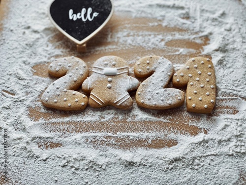 Covid concept gingerbreads on flour background for Christmas 2021 wallappers.