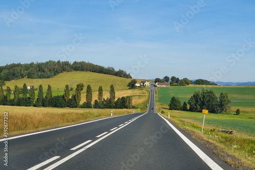 Asphalt road cutting through the rural landscape