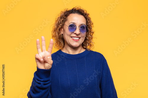 Slika na platnu hispanic middle age woman smiling and looking friendly, showing number three or