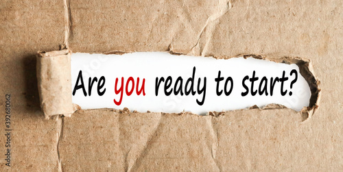 ARE YOU READY TO START, TEXT on white paper on torn paper background