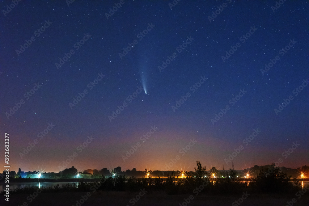 A magical starry night on the river by the Milky Way and a comet in the sky