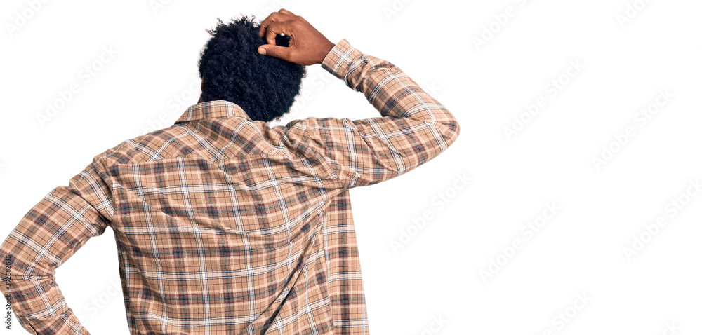 Handsome african american man with afro hair wearing casual clothes and glasses backwards thinking about doubt with hand on head Handsome african american man with afro hair wearing casual clothes and glasses backwards thinking about doubt with hand on head