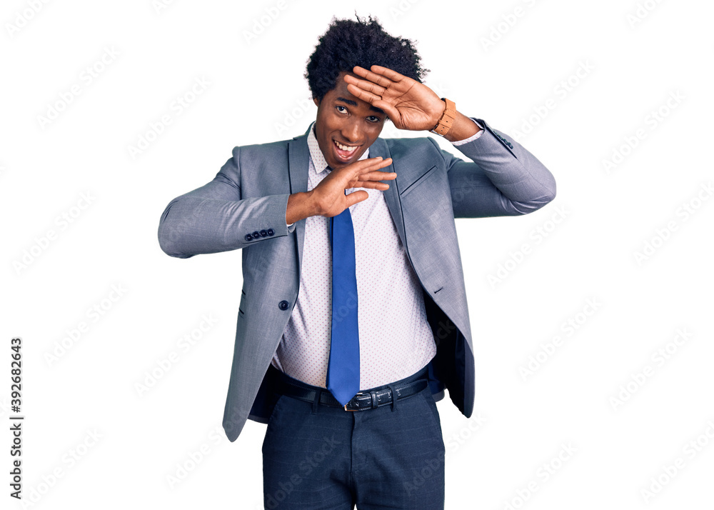 Handsome african american man with afro hair wearing business jacket smiling cheerful playing peek a boo with hands showing face. surprised and exited Handsome african american man with afro hair wearing business jacket smiling cheerful playing peek a boo with hands showing face. surprised and exited
