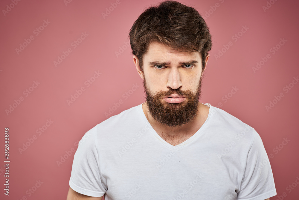 Man in white t-shirt emotions lifestyle facial expression cropped view pink background. Man in white t-shirt emotions lifestyle facial expression cropped view pink background.