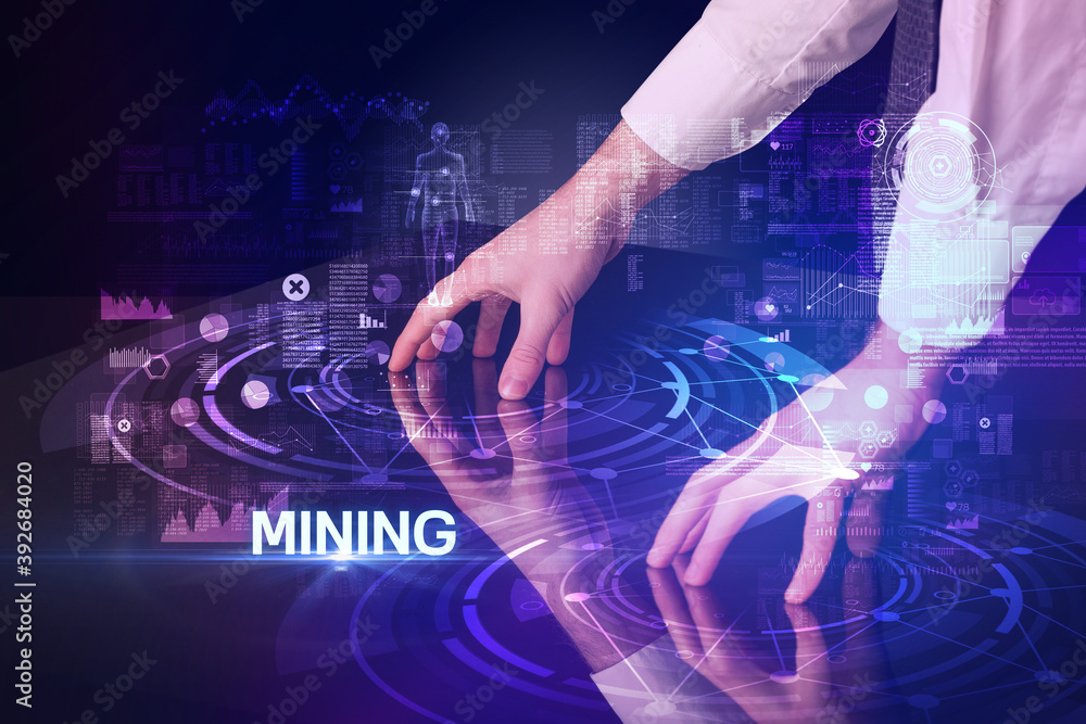 Businessman touching huge display with MINING inscription, modern technology concept Businessman touching huge display with MINING inscription, modern technology concept