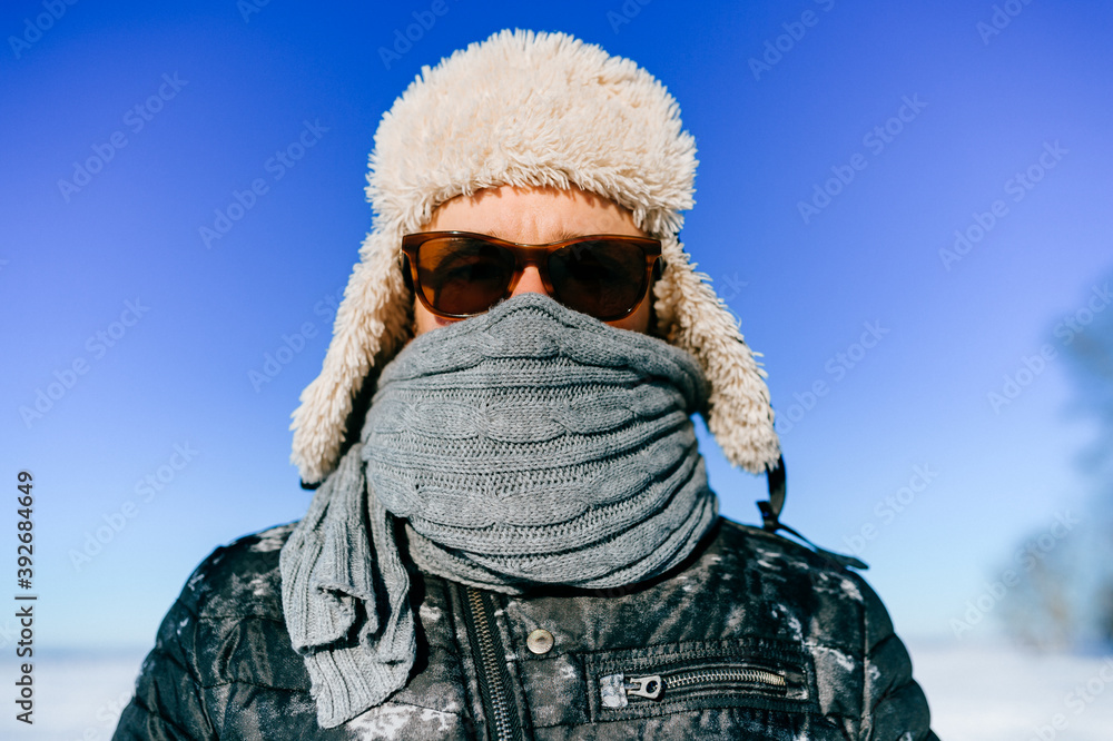 Portrait of frozen man in sunglasses posing outdoors Portrait of frozen man in sunglasses posing outdoors
