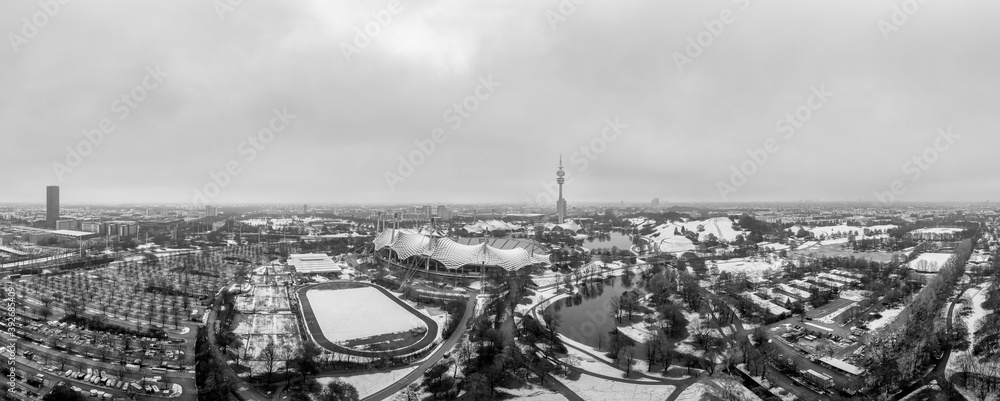 Obraz premium Snowy city of the popular tourism city of Munich in January, an aerial overview at wintertime in black and white.