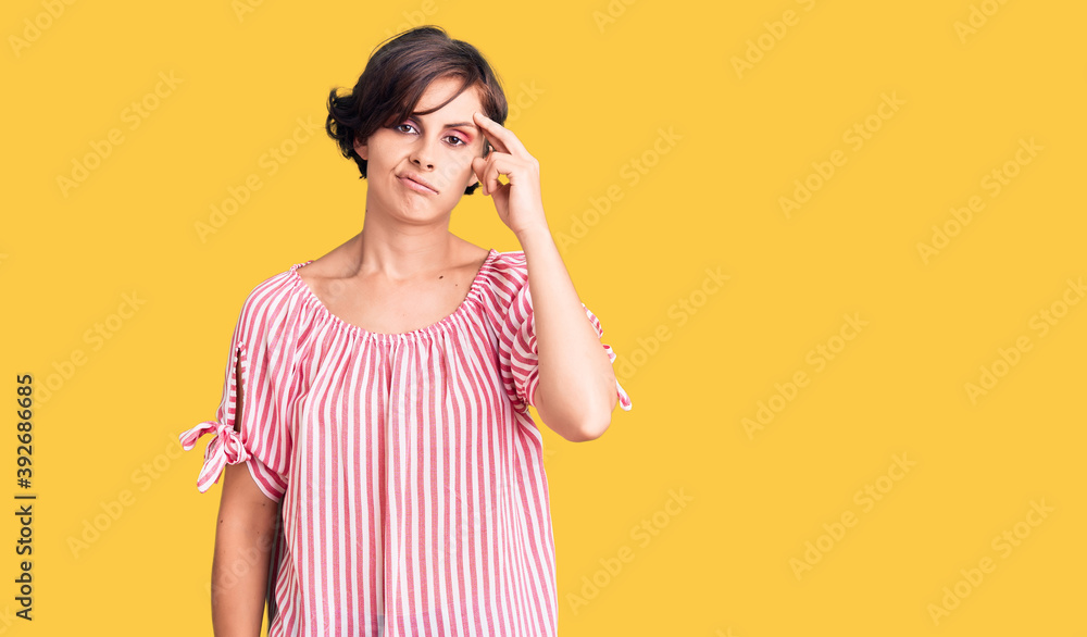 Beautiful young woman with short hair wearing casual summer clothes worried and stressed about a problem with hand on forehead, nervous and anxious for crisis Beautiful young woman with short hair wearing casual summer clothes worried and stressed about a problem with hand on forehead, nervous and anxious for crisis