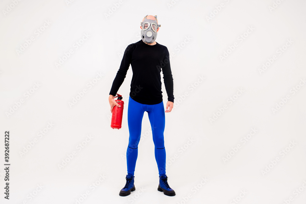Funny strange man in respirator with fire extinguisher posing over white background Funny strange man in respirator with fire extinguisher posing over white background
