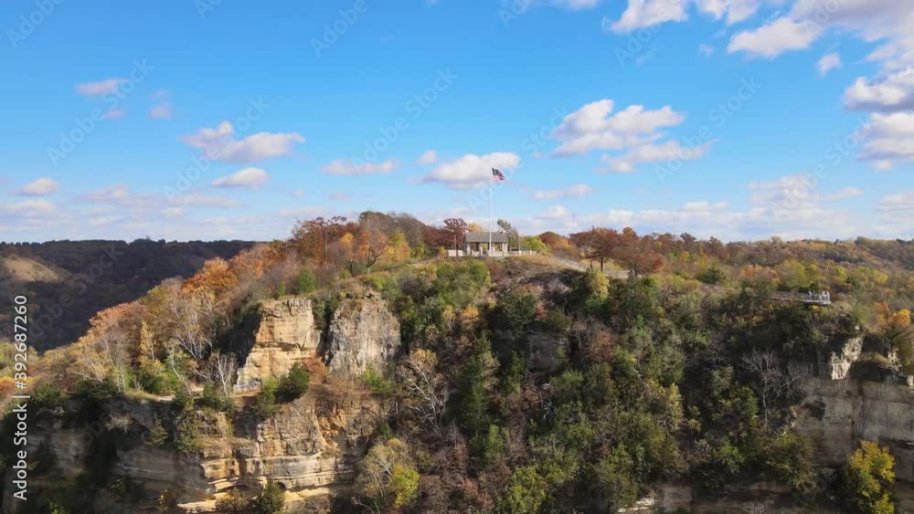 Colorful Fall Bluff with an American flag on the pole at the top of the mountain. Stunning aerial view of a house at the top of the mountain of Granddads Bluff in La Crosse, Wisconsin Colorful Fall Bluff with an American flag on the pole at the top of the mountain. Stunning aerial view of a house at the top of the mountain of Granddads Bluff in La Crosse, Wisconsin