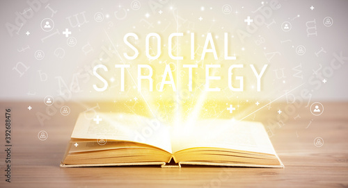 Open book with SOCIAL STRATEGY inscription, social media concept