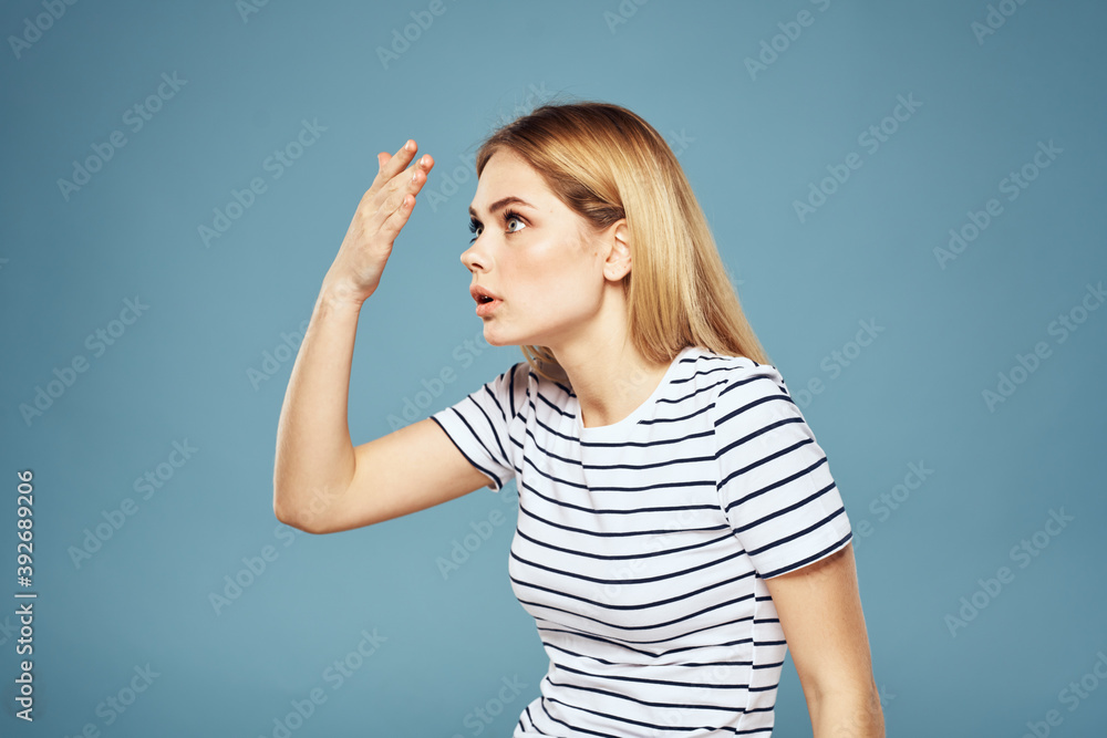 Upset woman emotions displeasure gestures with hands blue background